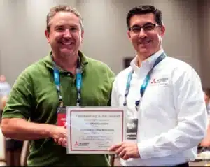 Jonathan Duncklee receiving the Mitsubishi Electric Outstanding Achievement Award at the Diamond Contractor convention