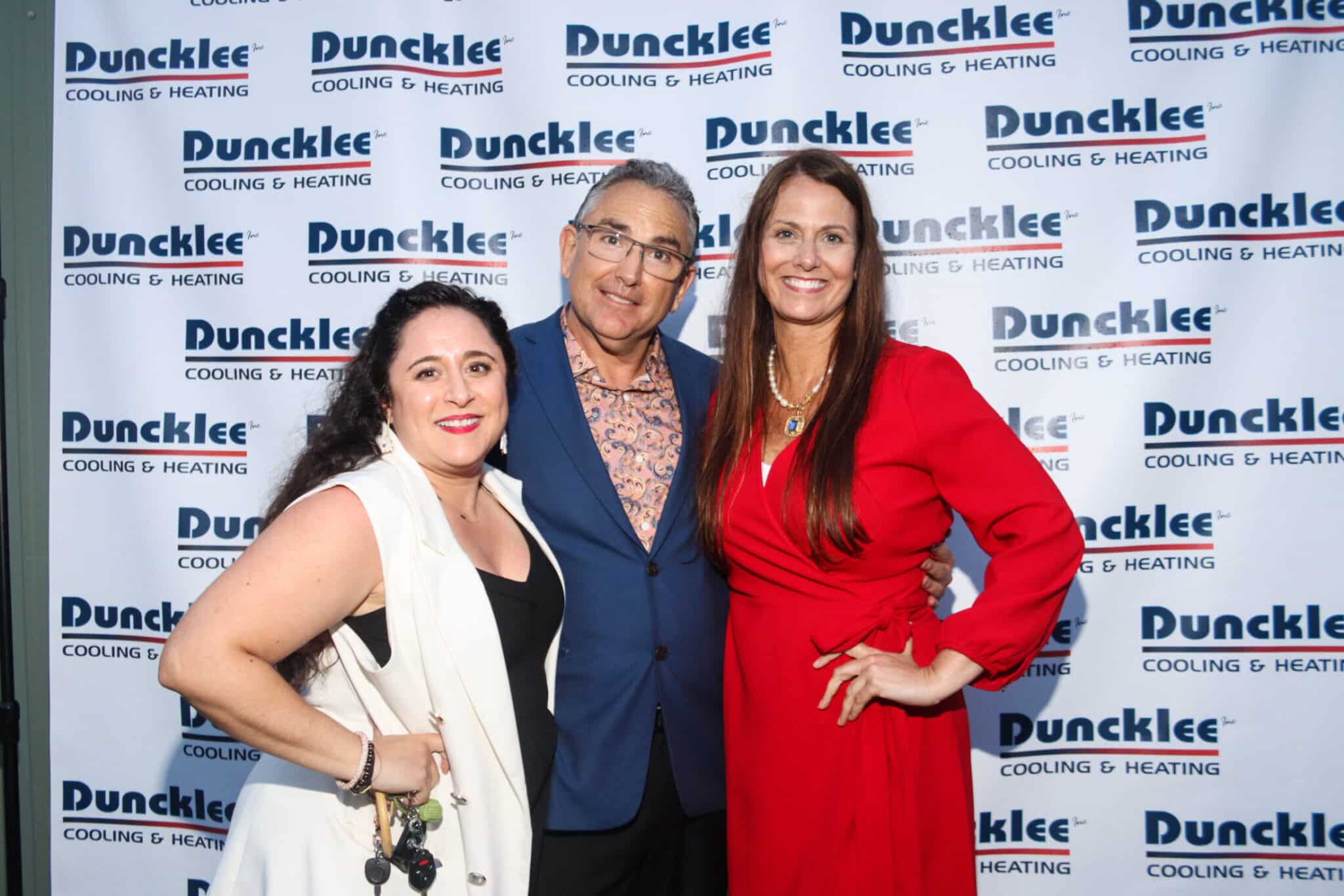 Duncklee Anniversary Family Portrait Stonington Family members posing together in front of the Duncklee 50th anniversary banner in Stonington, CT.