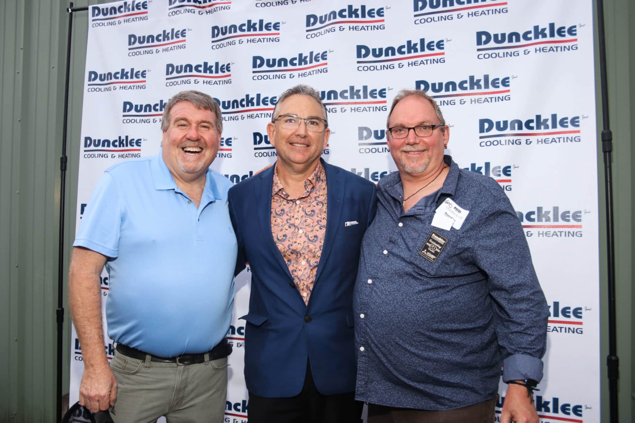 Friends of Duncklee Anniversary Stonington Three men posing for a celebratory photo at the Duncklee Cooling and Heating 50th anniversary in Stonington, CT.