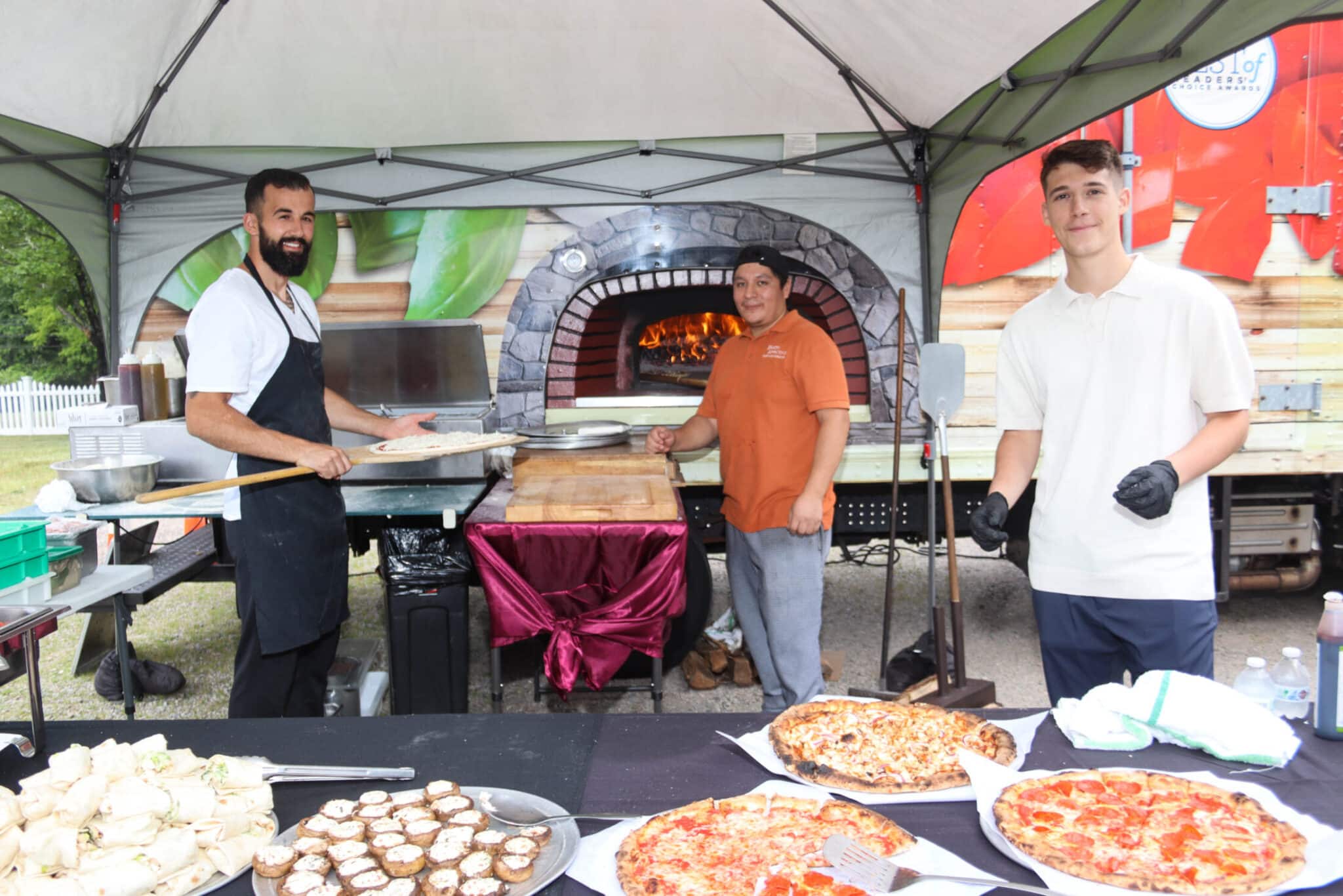 Outdoor Pizza Oven Duncklee Event Mystic Chefs preparing fresh pizza in an outdoor oven for the Duncklee 50th anniversary celebration in Mystic, CT
