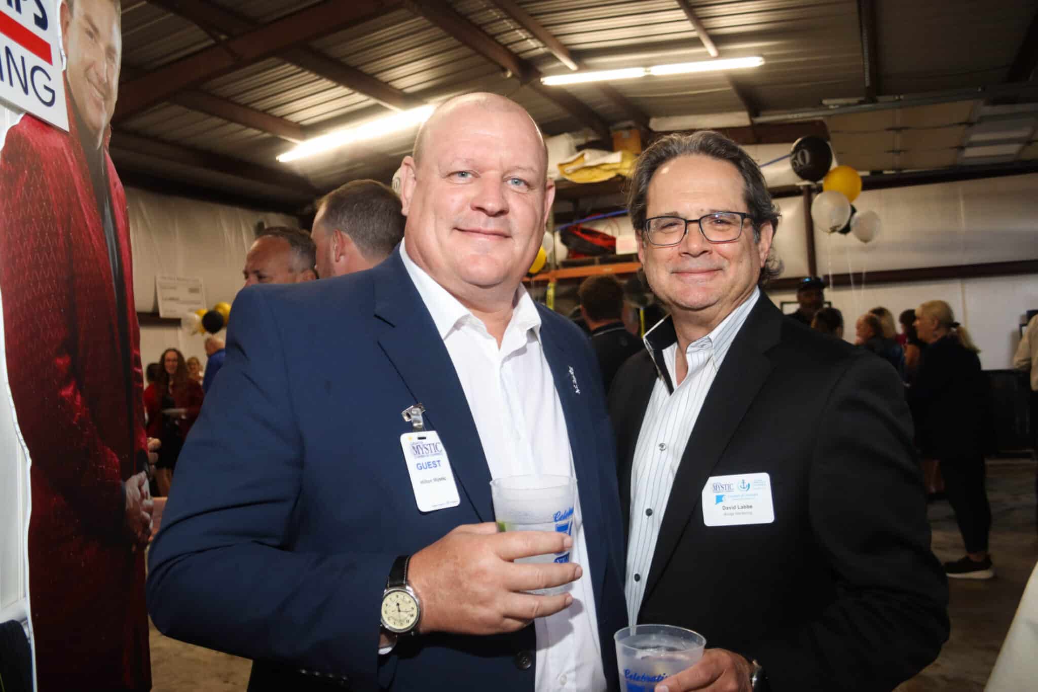 Professional Networking Duncklee Anniversary Mystic Two professional men sharing a conversation and smiling at the Duncklee Cooling and Heating anniversary party in Mystic, CT